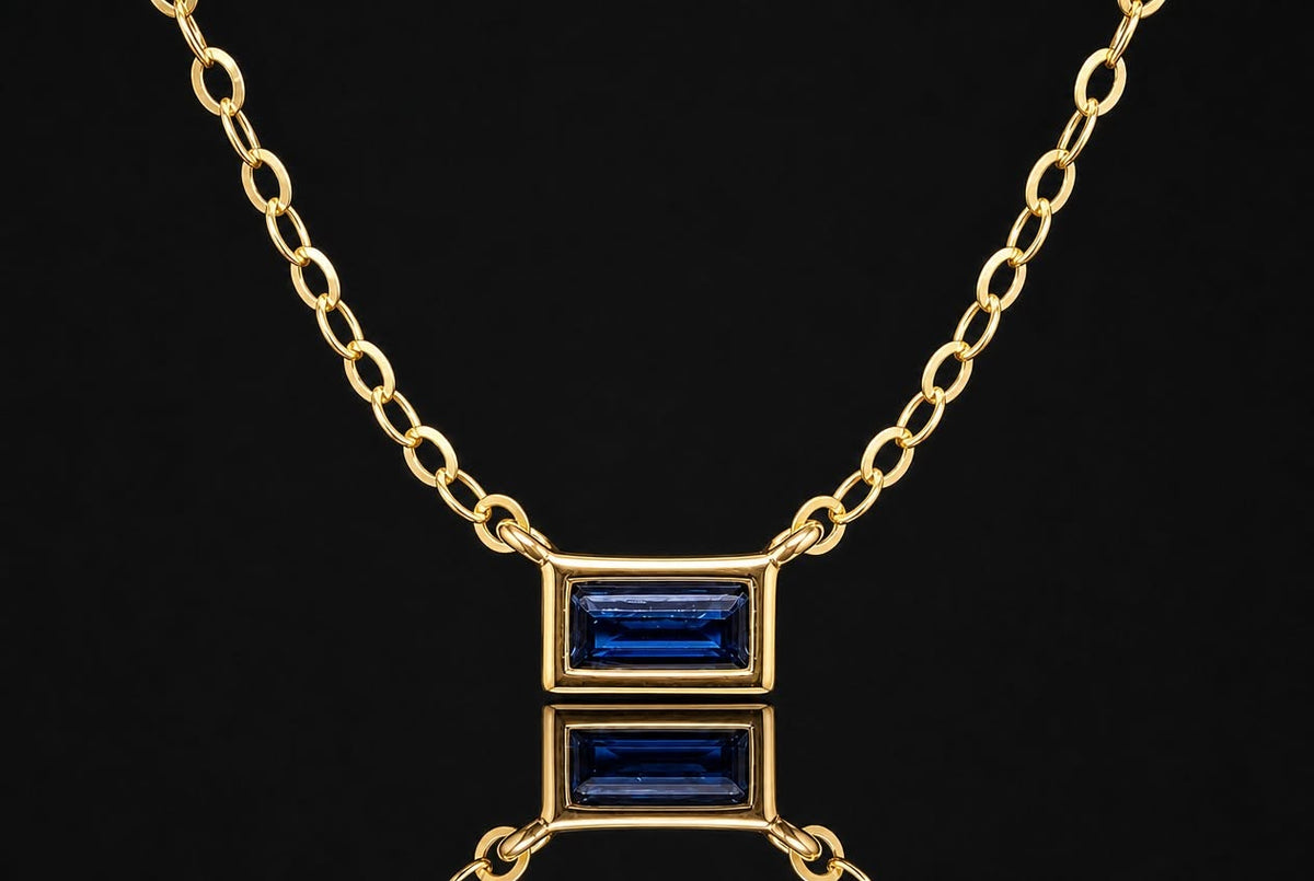 14K yellow gold necklace with a natural blue sapphire pendant