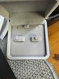 Pair of 14K white gold 1.50ctw lab diamond earrings displayed in a jewelry box