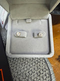 Pair of 14K yellow gold 1ct lab diamond earrings displayed in a jewelry box