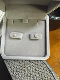 Pair of 10K yellow gold 0.50ctw earrings displayed in a jewelry box