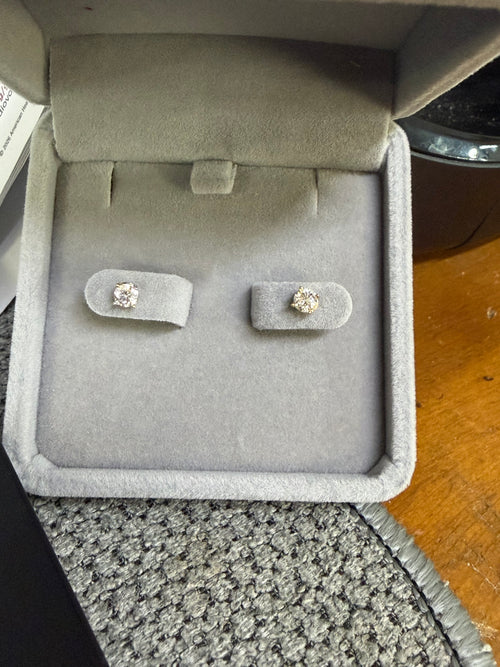 Pair of 10K yellow gold 0.50ctw earrings displayed in a jewelry box