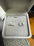 Pair of 14K yellow gold 0.75ctw lab diamond earrings displayed in a jewelry box
