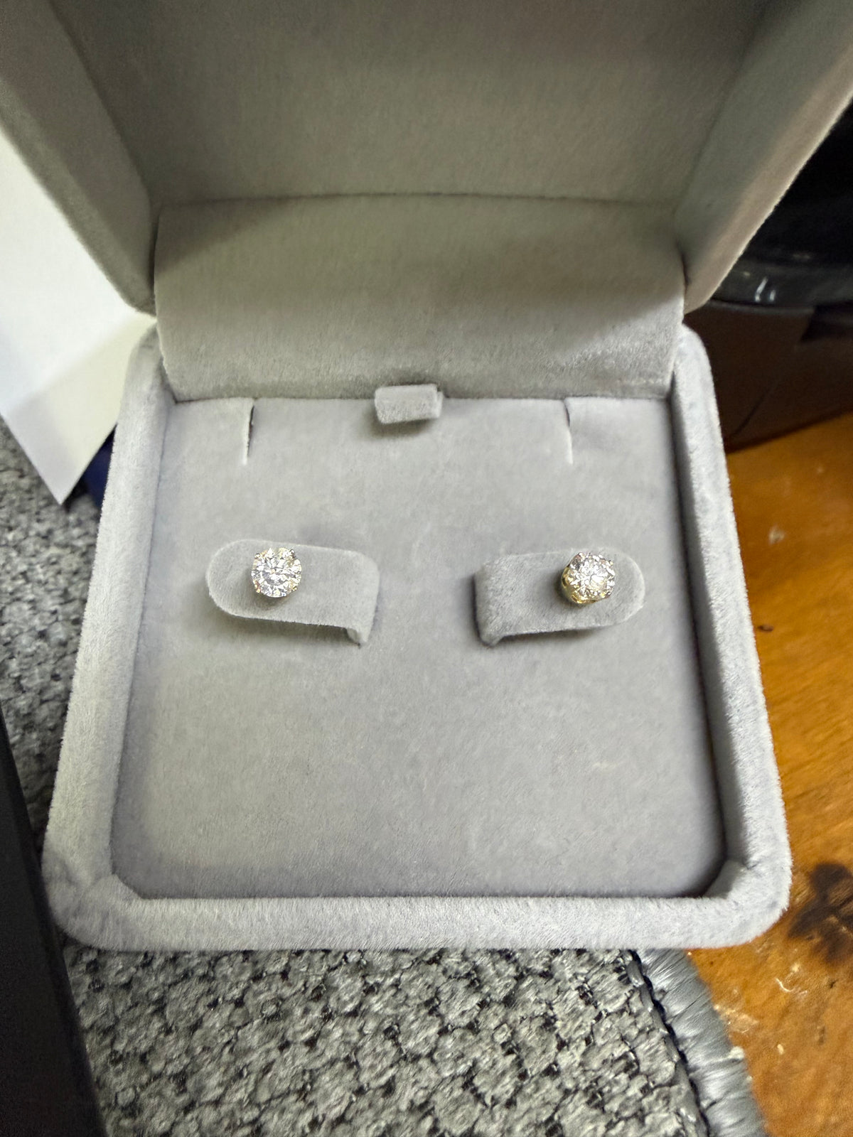 Pair of 14K yellow gold 0.75ctw lab diamond earrings displayed in a jewelry box