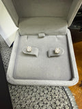 Pair of 14K yellow gold 1ct lab diamond earrings displayed in a jewelry box