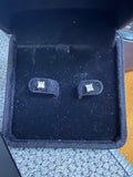 Pair of 14K white gold 0.50ctw natural princess-cut diamond earrings displayed in a jewelry box