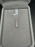 White gold necklace with a graduated natural diamond bar pendant displayed in a gray jewelry box