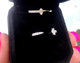 Diamond open-band rings shown on a black jewelry display